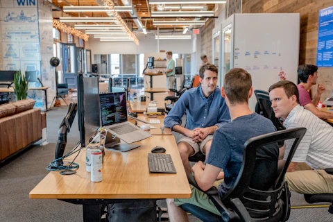Small team discussing work around a desk